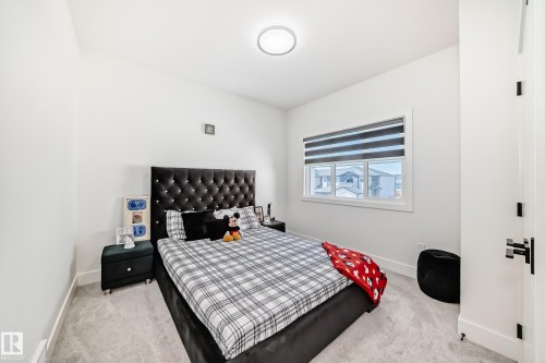 Bedroom featuring a large window with privacy blinds, light gray carpeting, and white walls - 17459 80 Street, Edmonton, AB - Indoor Photo Showing Bedroom