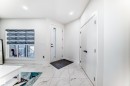 Entryway featuring large format marble-look tile flooring, a contemporary window with a privacy blind, and a modern door with an opaque glass insert - 17459 80 Street, Edmonton, AB  - Indoor Photo Showing Other Room 
