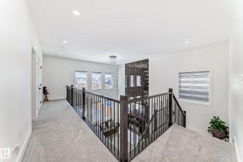 Upper-level hallway with light gray carpeting and white walls - 17459 80 Street, Edmonton, AB - Indoor Photo Showing Other Room