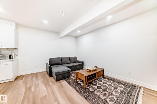 Open-concept living space featuring wood-finish flooring, recessed lighting, and a neutral color palette - 17459 80 Street, Edmonton, AB - Indoor