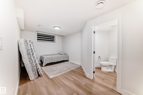 Bright room with wood-finish flooring, white walls, and a window with horizontal blinds - 17459 80 Street, Edmonton, AB - Indoor