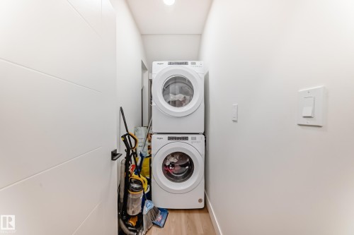 Dedicated laundry area featuring a stacked washer and dryer unit - 17459 80 Street, Edmonton, AB - Indoor Photo Showing Laundry Room