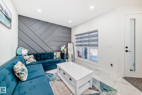Feature wall with geometric paneling, recessed lighting, and a window with privacy blinds - 17459 80 Street, Edmonton, AB - Indoor