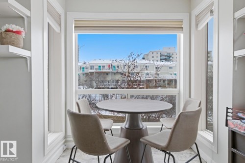 Bay window dining alcove featuring abundant natural light, a built-in window seat, and white trim molding - 115 10105 95 Street, Edmonton, AB - Indoor Photo Showing Dining Room