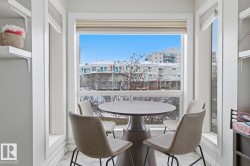 Bay window dining alcove featuring abundant natural light, a built-in window seat, and white trim molding - 