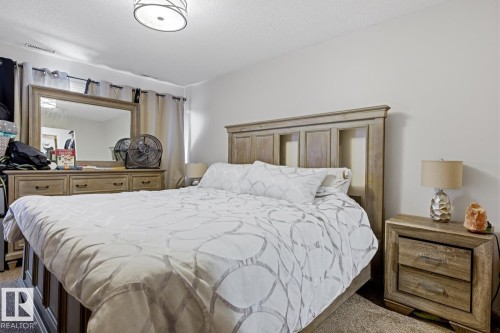 Bedroom featuring light-colored walls and soft pile carpeting - 115 10105 95 Street, Edmonton, AB - Indoor Photo Showing Bedroom