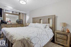 Bedroom featuring light-colored walls and soft pile carpeting - 