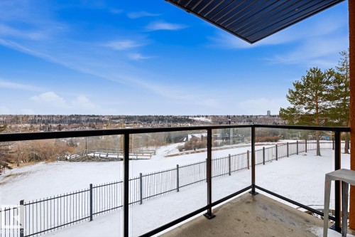 Exterior balcony featuring glass railings, a concrete floor, and an overhead soffit - 115 10105 95 Street, Edmonton, AB - Outdoor With Balcony With View