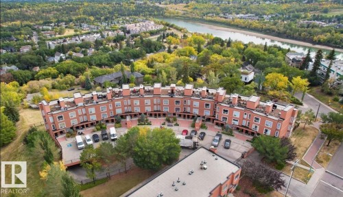 Terraced townhome complex featuring brick facades and individual rooftop patios - 115 10105 95 Street, Edmonton, AB - Outdoor With View