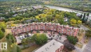 Terraced townhome complex featuring brick facades and individual rooftop patios - 115 10105 95 Street, Edmonton, AB  - Outdoor With View 