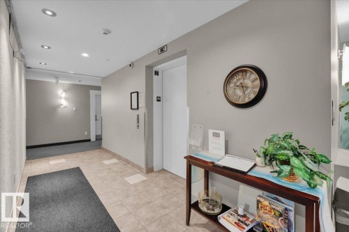 Elevator lobby featuring neutral wall tones, recessed ceiling lighting, and a durable tile flooring entrance - 326 6076 Schonsee Way, Edmonton, AB - Indoor Photo Showing Other Room