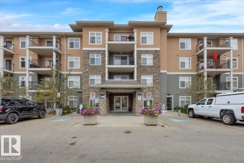 Multi-story residential building featuring a stone and siding exterior - 326 6076 Schonsee Way, Edmonton, AB - Outdoor With Balcony With Facade