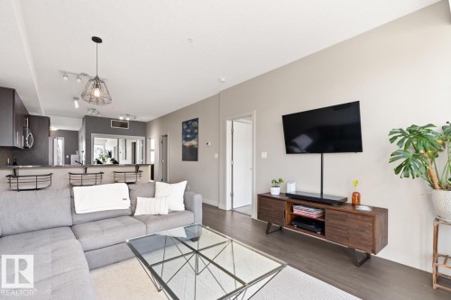 Spacious living area with dark flooring and light-colored walls - 406 10811 72 Avenue, Edmonton, AB - Indoor Photo Showing Living Room