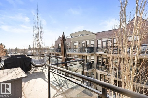This property offers a spacious outdoor patio area with views of the surrounding neighborhood and buildings - 406 10811 72 Avenue, Edmonton, AB - Outdoor