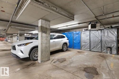 Underground parking space with concrete flooring and overhead lighting - 406 10811 72 Avenue, Edmonton, AB - Indoor Photo Showing Garage