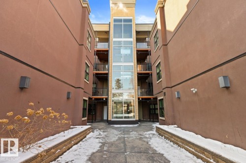 Exterior view of the property, featuring a glass elevator shaft and balconies with dark railings - 406 10811 72 Avenue, Edmonton, AB -  Photo Showing Other Room