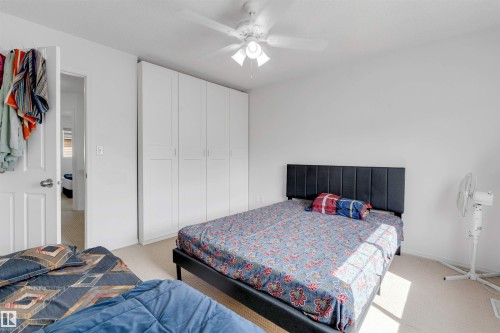 White walls and light-toned carpet create a bright interior - 48 2503 24 Street, Edmonton, AB - Indoor Photo Showing Bedroom