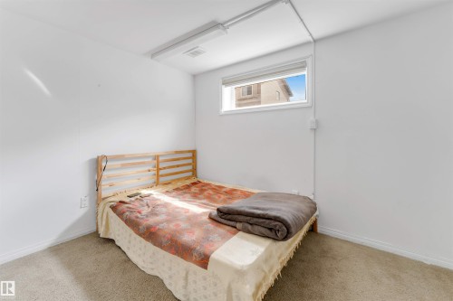 Bright room featuring neutral carpeting and white walls - 48 2503 24 Street, Edmonton, AB - Indoor Photo Showing Bedroom
