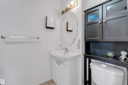 Bathroom vanity with white cabinetry, a ceramic sink, and chrome faucet hardware - 