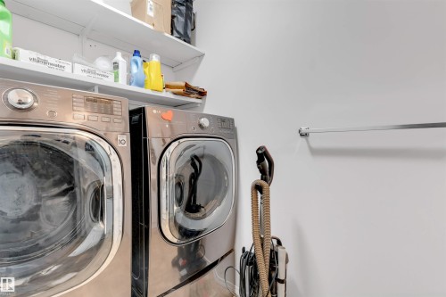 Dedicated laundry area featuring a built-in hanging rod and overhead shelving for added storage - 48 2503 24 Street, Edmonton, AB - Indoor Photo Showing Laundry Room