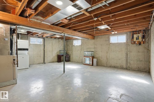 Unfinished basement with exposed wood joists and concrete flooring - 15811 114 Street, Edmonton, AB - Indoor Photo Showing Basement