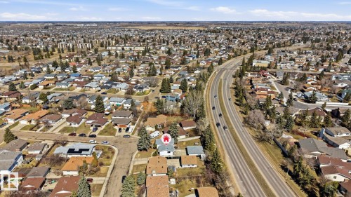 Residential neighborhood featuring varied housing styles, mature landscaping, and a multi-lane roadway - 15811 114 Street, Edmonton, AB - Outdoor With View