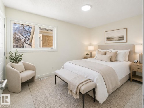 Carpeted room with a double window, light-colored walls, and a ceiling-mounted light fixture - 15C Callingwood Crest, Edmonton, AB - Indoor Photo Showing Bedroom