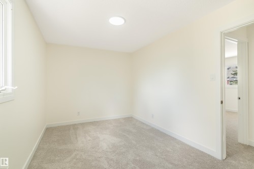 Light-colored walls and grey carpet flooring - 15C Callingwood Crest, Edmonton, AB - Indoor Photo Showing Other Room