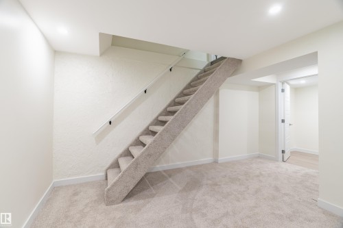 Carpeted staircase with a white handrail, leading to an upper level - 15C Callingwood Crest, Edmonton, AB - Indoor Photo Showing Other Room