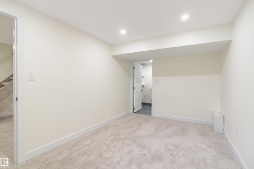 Carpeted room with recessed lighting and a neutral color palette - 15C Callingwood Crest, Edmonton, AB - Indoor Photo Showing Other Room