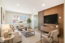Living room featuring a wood-panel accent wall, recessed lighting, large picture window, and wood-finish flooring - 15C Callingwood Crest, Edmonton, AB  - Indoor Photo Showing Living Room 