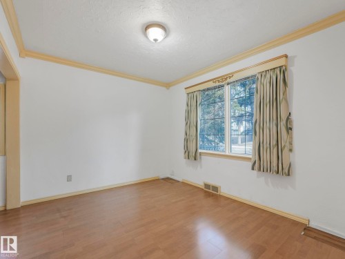 Room featuring wood-finish flooring, white walls, and decorative crown molding - 11643 76 Avenue, Edmonton, AB - Indoor Photo Showing Other Room