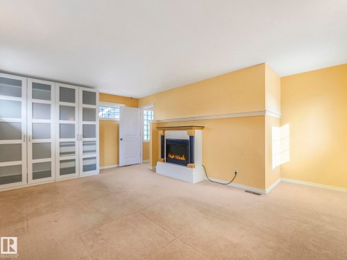Built-in fireplace with a white mantel and dark surround - 11643 76 Avenue, Edmonton, AB - Indoor With Fireplace