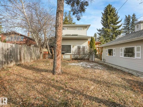 Rear exterior of the property featuring a light-colored siding facade - 11643 76 Avenue, Edmonton, AB - Outdoor