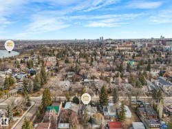 Aerial perspective showcasing a residential neighborhood with a variety of housing styles and mature trees - 