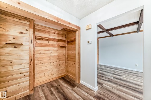 Wood planked accent wall with integrated shelving - 3325 107 Avenue Nw, Edmonton, AB - Indoor Photo Showing Other Room