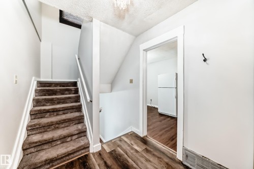 Interior staircase with carpeted treads and white risers - 3325 107 Avenue Nw, Edmonton, AB - Indoor Photo Showing Other Room