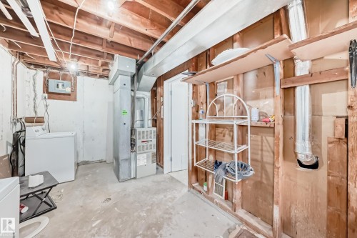 Basement utility area featuring exposed wood ceiling joists and concrete flooring - 3325 107 Avenue Nw, Edmonton, AB - Indoor Photo Showing Basement