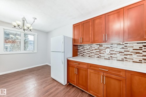 Kitchen featuring wood-finish flooring and a multi-pane window - 3325 107 Avenue Nw, Edmonton, AB - Indoor