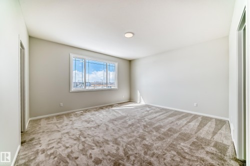 This room features light-colored walls and soft pile carpeting - 1516 206 Street Nw, Edmonton, AB - Indoor Photo Showing Other Room