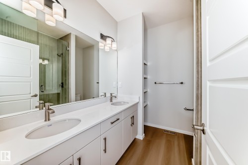 Bathroom featuring a dual vanity with white countertops, light gray cabinetry, and a large mirror - 1516 206 Street Nw, Edmonton, AB - Indoor Photo Showing Bathroom