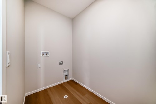 Dedicated utility space featuring light-colored walls and wood-look flooring - 1516 206 Street Nw, Edmonton, AB - Indoor Photo Showing Other Room