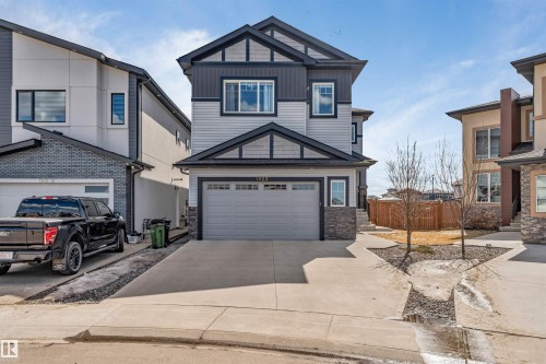 Modern two-story residence featuring light gray siding and dark gray architectural accents - 1923 19 Avenue, Edmonton, AB - Outdoor