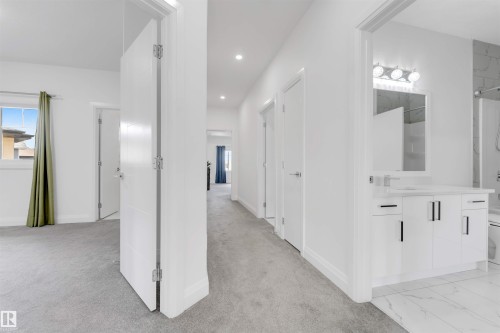 Bright hallway featuring light gray carpeting and recessed lighting - 1923 19 Avenue, Edmonton, AB - Indoor Photo Showing Other Room