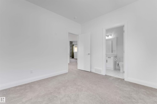 Neutral-toned wall-to-wall carpeting in a spacious room - 1923 19 Avenue, Edmonton, AB - Indoor Photo Showing Other Room
