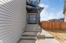 Front entry featuring a multi-paneled door with frosted glass inserts, concrete steps, and a black metal handrail - 1923 19 Avenue, Edmonton, AB  - Outdoor With Exterior 