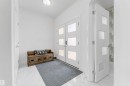 Entryway featuring white tile flooring, double entry doors with frosted glass panels, and a modern interior door with frosted glass - 1923 19 Avenue, Edmonton, AB  - Indoor Photo Showing Other Room 