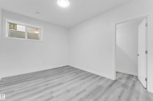 Room featuring light wood-finish flooring, white walls, and white trim - 1923 19 Avenue, Edmonton, AB - Indoor Photo Showing Other Room