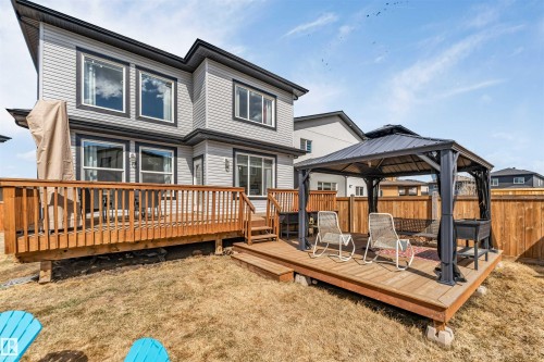Expansive rear yard featuring a large wooden deck and a detached wooden gazebo platform - 1923 19 Avenue, Edmonton, AB - Outdoor With Deck Patio Veranda