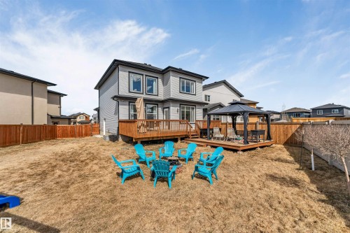 Expansive backyard featuring a multi-level wood deck, a covered gazebo, and a full wooden privacy fence - 1923 19 Avenue, Edmonton, AB - Outdoor With Deck Patio Veranda